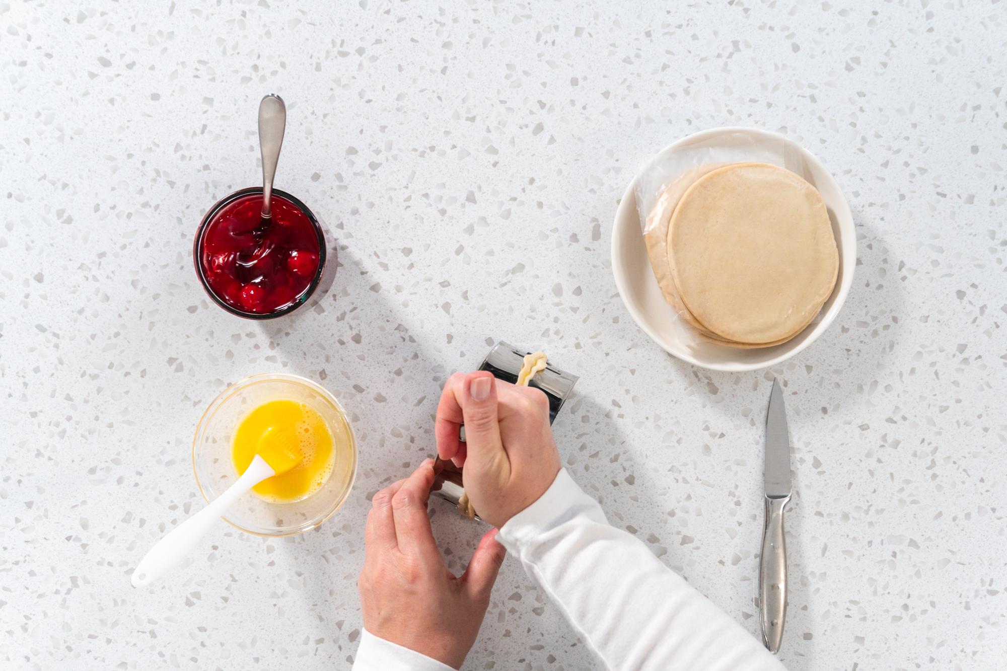 hand whisking a sauce in a mixing bowl