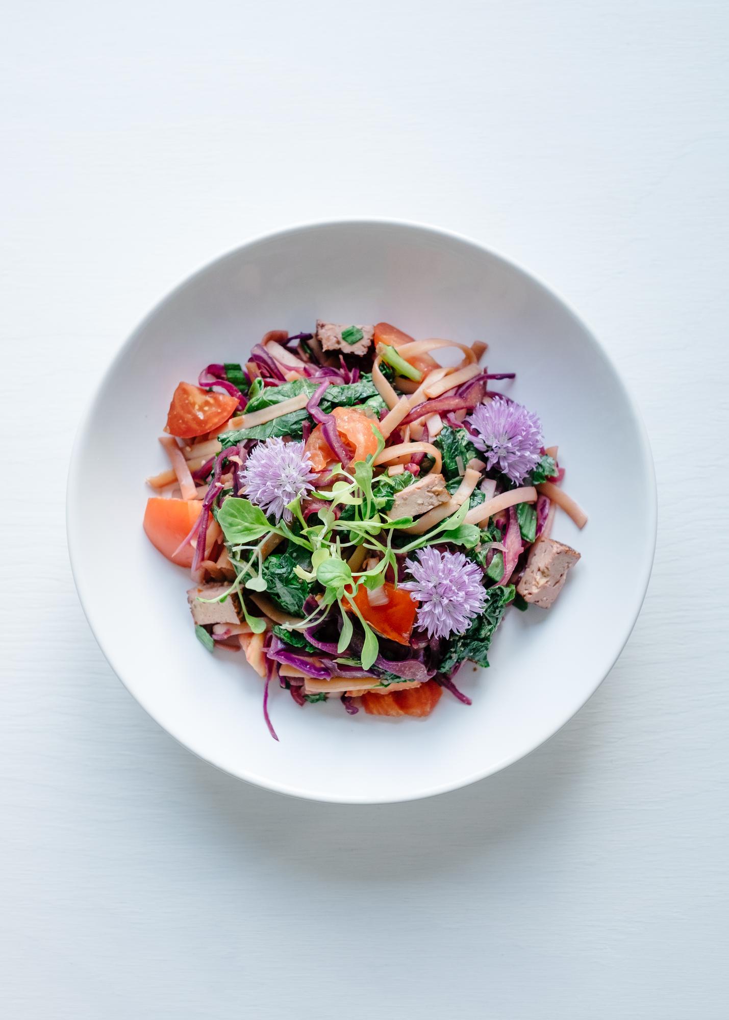 plated seasonal salad with edible flowers